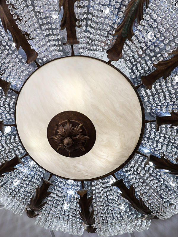 A view looking directly up at the majestic chandelier in the Ballroom of The Walden Club.