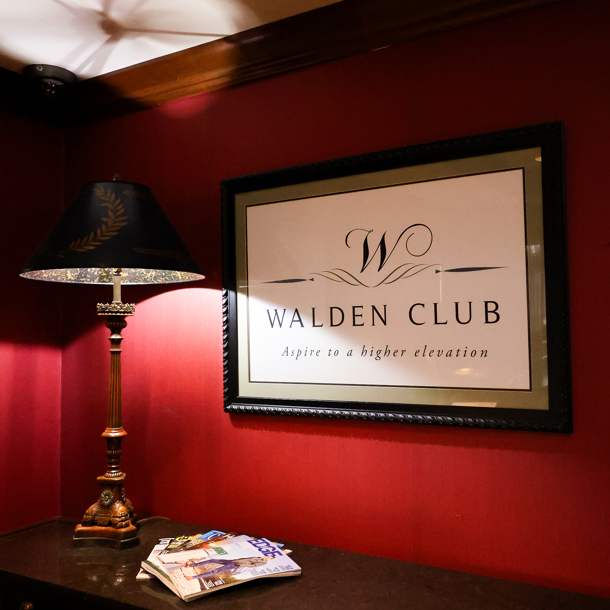 The Walden Club framed logo hanging on the lobby wall.